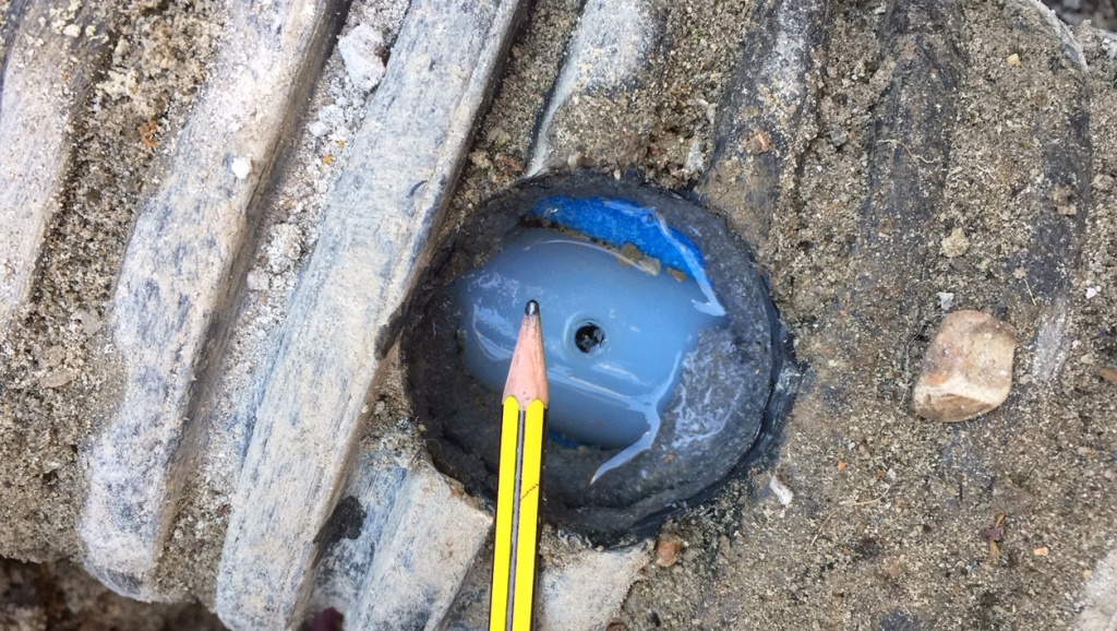 Pinhole leak cut into a underground heating pipe