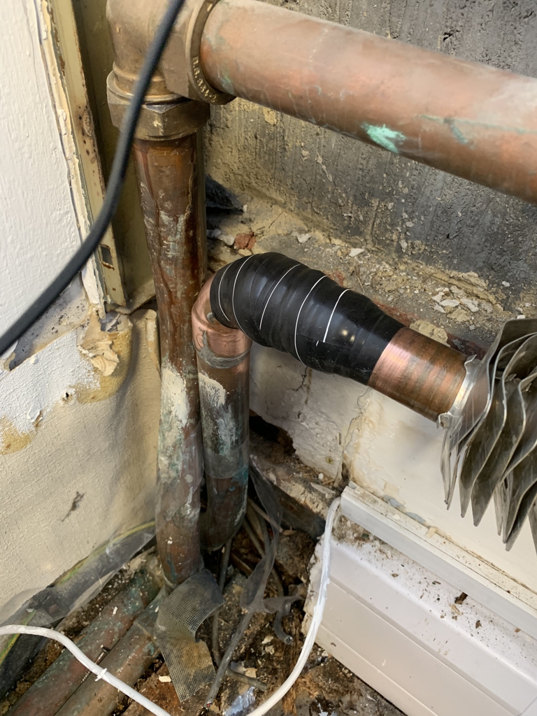 Domestic copper heating pipe leaking from a badly soldered joint repaired with Wrap & Seal