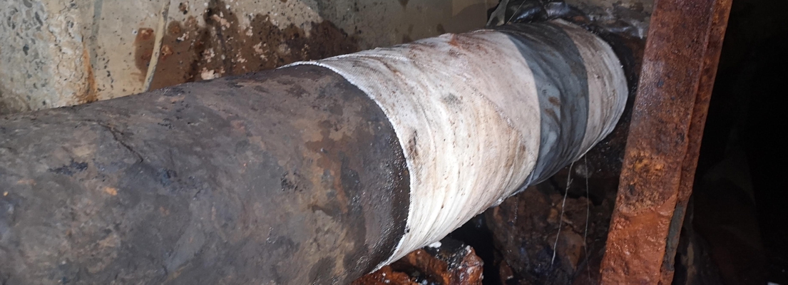 A heavy duty pipe in a district heating system repair carried out using a SylWrap Pipe Repair Kit
