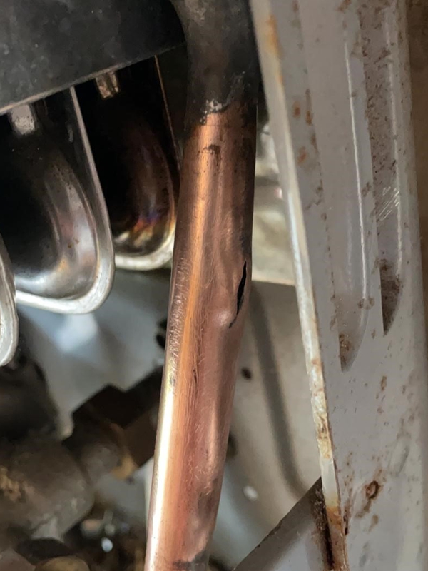 A crack in a copper pipe in a camper van boiler system