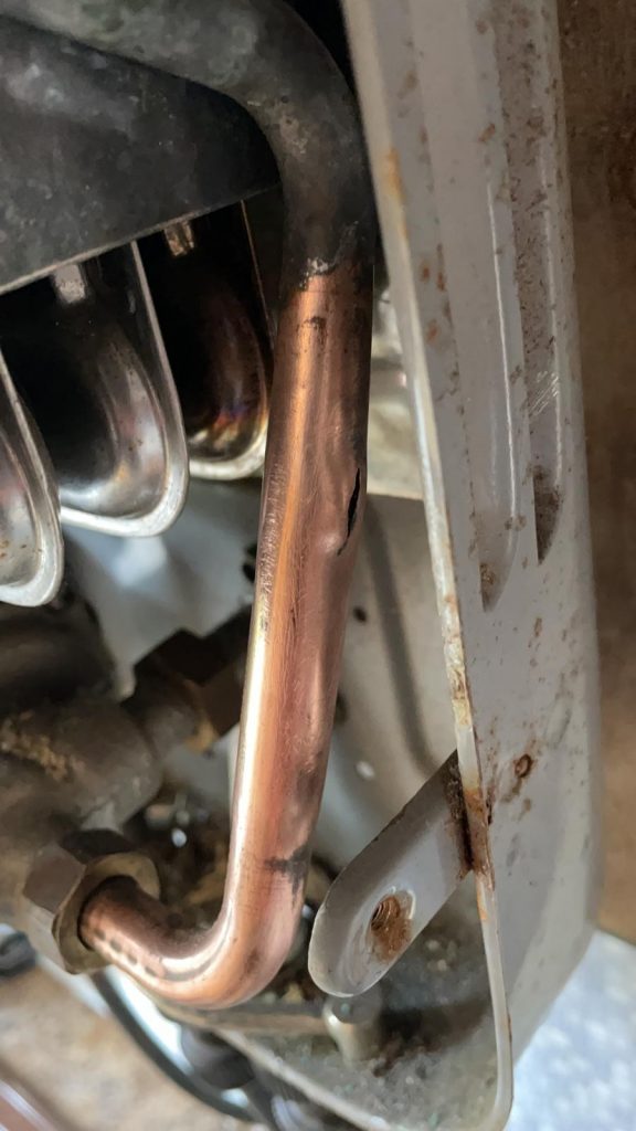A crack in a copper pipe in a camper van boiler system