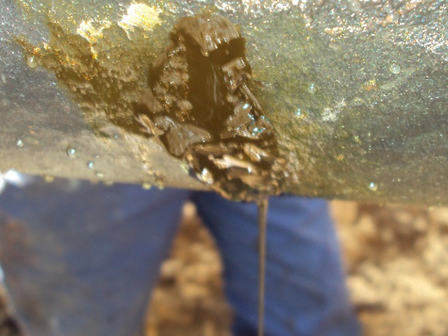 Crack in a fuel oil line caused by a corrosion prior to undergoing repair using SylWrap