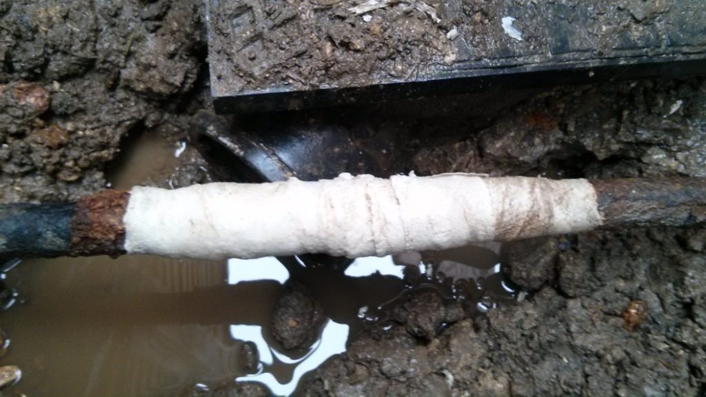 Completed repair of a 90-year-old malleable iron water supply pipe damaged by corrosion