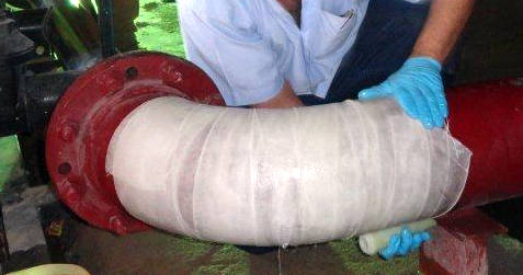 SylWrap HD applied to an elbow bend as part of the reinforcement of a heavily corroded steel pipe