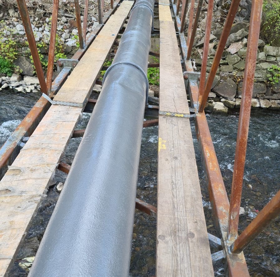 Liquid Metal Epoxy Coating creates a new metallic surface around a heavily corroded pipe bridge requiring repair