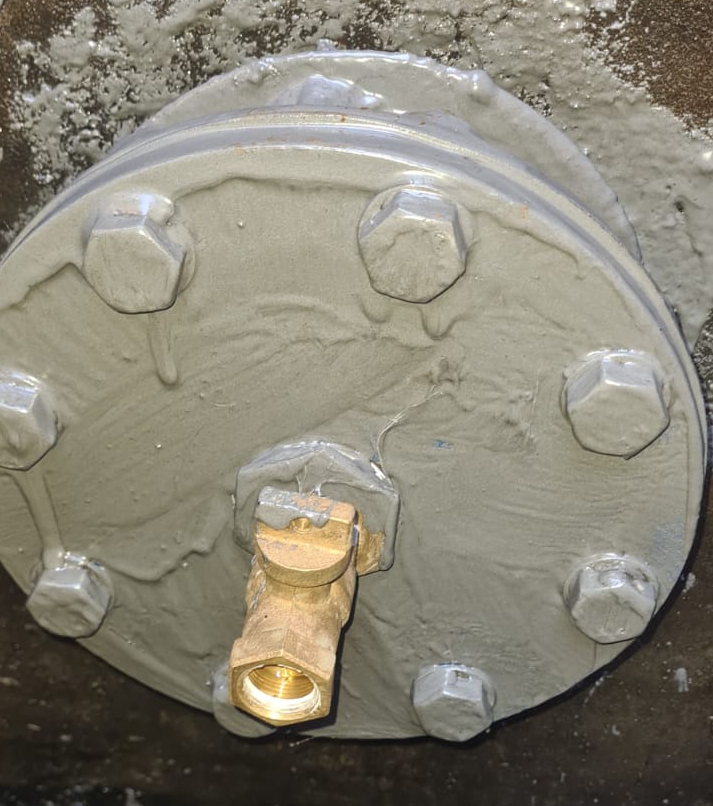 Liquid Metal applied to a pipe flange plate as part of the encapsulation of a stub plate