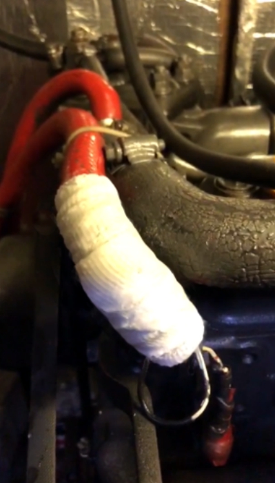 A rubber hose in a boat engine leaking through a pinhole fixed using SylWrap Standard Pipe Repair Kit