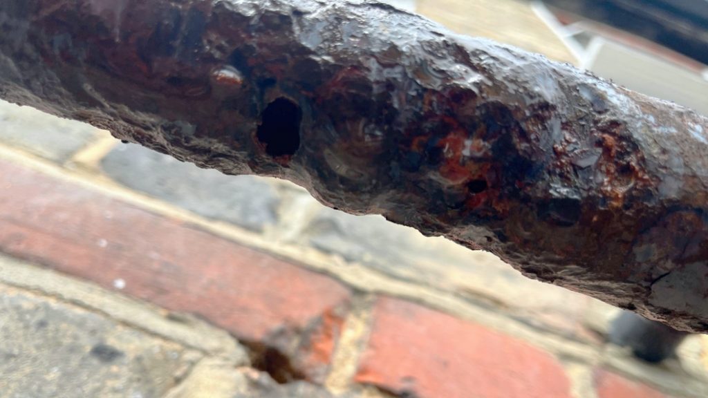 Cracks in a corroded shared water supply before undergoing repair with Superfast Aqua PW Epoxy Putty