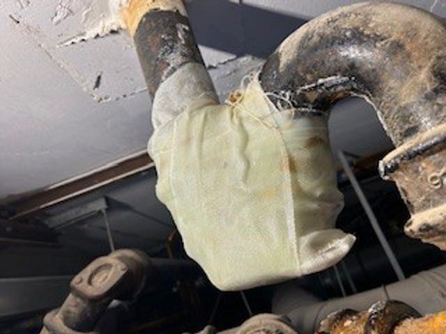 SylWrap HD Pipe Repair Bandage effectively wrapped around a cast iron waste pipe U-bend despite the difficult geometry at a hospital