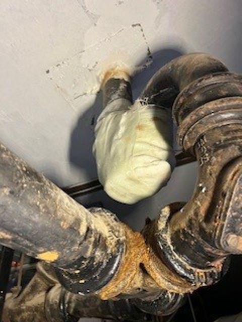 SylWrap HD Pipe Repair Bandage used to reinforce a leaking cast iron waste pipe U-bend at a UK hospital