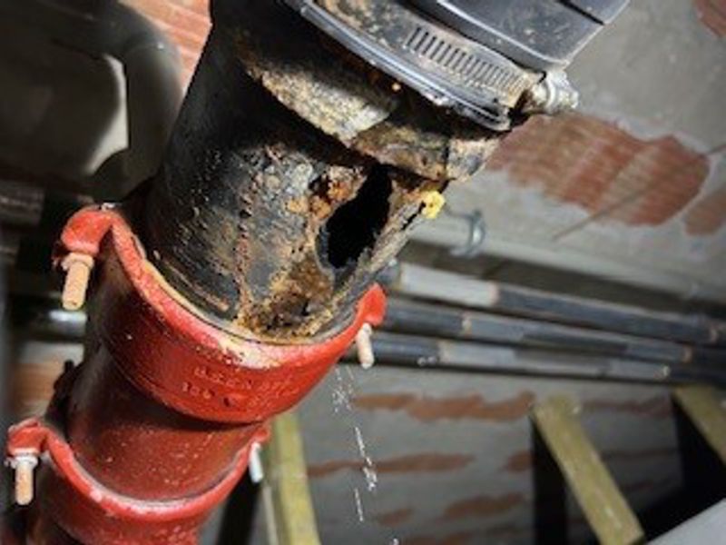 80mm hole in a cast iron wastewater drain pipe before repair with Superfast Steel Epoxy Putty