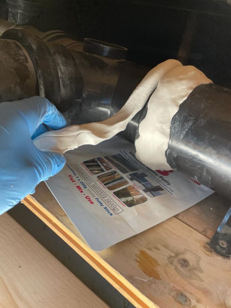 Sylmasta AB Original Epoxy Putty applied to a plastic pipe joint to repair a leak caused by solvent cement failure